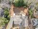 An aerial view of a house with a dark roof, driveway, and mature trees at 1905 Castleway Ne Ln, Atlanta, GA 30345