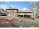 A house with a brick and brown siding exterior and a large deck in the backyard at 1905 Castleway Ne Ln, Atlanta, GA 30345