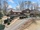 A winding driveway leads to this charming two-story house with stone accents and mature landscaping at 1905 Castleway Ne Ln, Atlanta, GA 30345