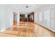 Open-concept living space with wood floors and access to the kitchen and outdoor area at 1905 Castleway Ne Ln, Atlanta, GA 30345