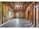 Unfinished basement with exposed framing, concrete floor and walkout door to the yard at 313 Sable Trace Pass, Acworth, GA 30102
