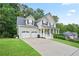 Lovely two-story home features a two-car garage, covered entry and neatly maintained lawn at 313 Sable Trace Pass, Acworth, GA 30102