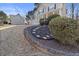 Well-maintained front yard features brick retaining wall with mulch bed, and stepping stones at 313 Sable Trace Pass, Acworth, GA 30102