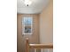 Stairwell landing featuring window with curtains, wood banister and neutral wall color at 313 Sable Trace Pass, Acworth, GA 30102