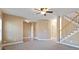 Spacious living room with a staircase, carpeted floors, and neutral paint, offering versatility at 313 Sable Trace Pass, Acworth, GA 30102