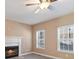 Cozy living room with a fireplace, neutral walls, and bright windows, perfect for relaxing and entertaining at 313 Sable Trace Pass, Acworth, GA 30102