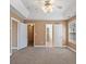 Spacious main bedroom with carpet, tray ceilings, lighted fan and a large window at 313 Sable Trace Pass, Acworth, GA 30102