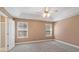 Spacious main bedroom featuring plush carpet, tray ceiling, and a ceiling fan at 313 Sable Trace Pass, Acworth, GA 30102