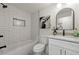 Updated bathroom featuring a soaking tub, marble floors, and modern fixtures at 4538 Arcado Sw Rd, Lilburn, GA 30047