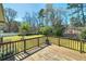 A spacious back deck offers stunning views of the landscaped yard and surrounding greenery at 115 Heritage Cir, Mcdonough, GA 30253