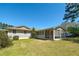 A charming backyard features lush lawn, screened porch, and mature landscaping at 115 Heritage Cir, Mcdonough, GA 30253