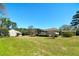 Ranch home with screened-in porch, wooden deck, outbuilding, and spacious, grassy backyard at 115 Heritage Cir, Mcdonough, GA 30253