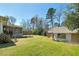 Enjoy the outdoors in this backyard with lush lawn, a deck, screened porch, and mature trees at 115 Heritage Cir, Mcdonough, GA 30253