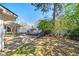 The backyard offers a serene retreat, featuring a brick patio, mature landscaping, and a lush lawn at 115 Heritage Cir, Mcdonough, GA 30253