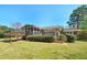 A well-maintained backyard with deck, screen porch, mature trees and a lush lawn at 115 Heritage Cir, Mcdonough, GA 30253