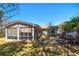 The cozy backyard features a screened porch, patio area, mature trees, and landscaping at 115 Heritage Cir, Mcdonough, GA 30253