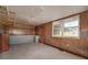 Spacious garage with built-in cabinetry for storage and natural light from exterior window at 115 Heritage Cir, Mcdonough, GA 30253