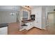 Spacious kitchen featuring white cabinetry and breakfast bar, open to living room at 115 Heritage Cir, Mcdonough, GA 30253