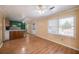 An open living room with hardwood floors and natural light, seamlessly connecting to the kitchen area at 115 Heritage Cir, Mcdonough, GA 30253