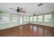 Bright sunroom with hardwood floors, ceiling fans, and lots of windows offering plenty of natural light at 115 Heritage Cir, Mcdonough, GA 30253