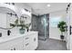 Elegant bathroom boasts dual sinks, modern fixtures, and glass enclosed shower at 1785 Hammond Woods Sw Cir, Marietta, GA 30008