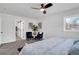Bright bedroom features stylish ceiling fan, sitting area, and view to outside at 1785 Hammond Woods Sw Cir, Marietta, GA 30008