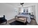Calming bedroom features neutral walls, plush carpet, accent pillows, and lots of natural light from two windows at 1785 Hammond Woods Sw Cir, Marietta, GA 30008