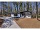 Charming renovated home featuring a carport and a well-manicured front yard and blue front door at 1785 Hammond Woods Sw Cir, Marietta, GA 30008