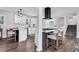 Modern, open kitchen featuring stainless appliances, island seating, and flowing into the living area at 1785 Hammond Woods Sw Cir, Marietta, GA 30008