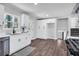 Bright kitchen with white cabinets, stainless steel appliances, hardwood floors, and a view to stairs at 1785 Hammond Woods Sw Cir, Marietta, GA 30008