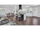 Open concept living room shows island seating, hardwood flooring, and a view into the dining area at 1785 Hammond Woods Sw Cir, Marietta, GA 30008