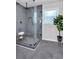 Glass enclosed shower features tile surround and modern rainfall shower head at 1785 Hammond Woods Sw Cir, Marietta, GA 30008