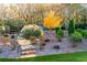 Backyard features a stone staircase amidst green grass, bushes, and several trees at 201 Edwards Brook Ct, Canton, GA 30115