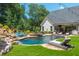 Resort-style pool area with a waterfall, lush landscaping, and comfortable lounge seating at 201 Edwards Brook Ct, Canton, GA 30115