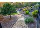 A picturesque backyard with a stone path, lush landscaping, and seating area at 201 Edwards Brook Ct, Canton, GA 30115