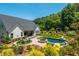Enjoy outdoor living with a patio, in-ground pool, spa, outdoor fireplace, and manicured garden for leisure and entertaining at 201 Edwards Brook Ct, Canton, GA 30115