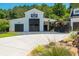 A barn featuring black garage doors, a 'Golden Willow Barn' sign, and surrounding greenery at 201 Edwards Brook Ct, Canton, GA 30115