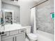 Modern bathroom featuring a vessel sink, granite countertops, and tiled shower with built-in shelves at 201 Edwards Brook Ct, Canton, GA 30115