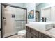 Modern bathroom featuring a walk-in shower with sleek glass doors and a stylish vanity at 201 Edwards Brook Ct, Canton, GA 30115