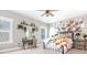 Bright bedroom with decorative wall art, floating shelves, and an inviting bed with a pumpkin-themed blanket at 201 Edwards Brook Ct, Canton, GA 30115