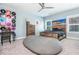 Stylish bedroom featuring a cozy beanbag chair, unique wall art, and a modern ceiling fan at 201 Edwards Brook Ct, Canton, GA 30115