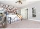 Bright bedroom with decorative wall art, floating shelves, and an inviting bed with a pumpkin-themed blanket at 201 Edwards Brook Ct, Canton, GA 30115