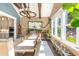 Open-concept dining room with exposed brick, dog bowls, and a view to the kitchen and backyard at 201 Edwards Brook Ct, Canton, GA 30115