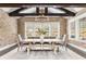 Elegant dining room with exposed beams, brick accent wall, chandelier and large windows at 201 Edwards Brook Ct, Canton, GA 30115