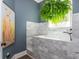 Dedicated dog bath area showcasing marble tiling, a handheld sprayer, and a decorative plant at 201 Edwards Brook Ct, Canton, GA 30115