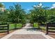 Long private driveway lined with trees and lush greenery provides a grand entrance to the beautiful property at 201 Edwards Brook Ct, Canton, GA 30115