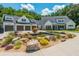 Stunning farmhouse exterior showcasing a tranquil rock pond and manicured landscaping at 201 Edwards Brook Ct, Canton, GA 30115