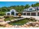 Estate featuring a detached garage, a barn, a pond with stepping stones, and professional landscaping at 201 Edwards Brook Ct, Canton, GA 30115