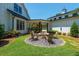Enjoy the backyard fire pit area with comfortable seating and green grass surrounding the home, perfect for relaxing and entertaining at 201 Edwards Brook Ct, Canton, GA 30115