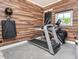 Home gym featuring wood walls, a treadmill and an elliptical machine at 201 Edwards Brook Ct, Canton, GA 30115